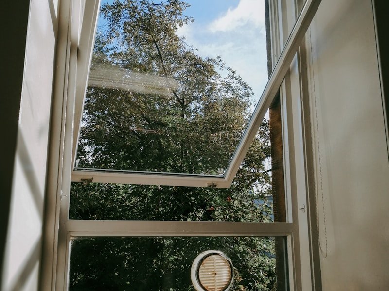 An awning sash cranked open outward above an interior sill