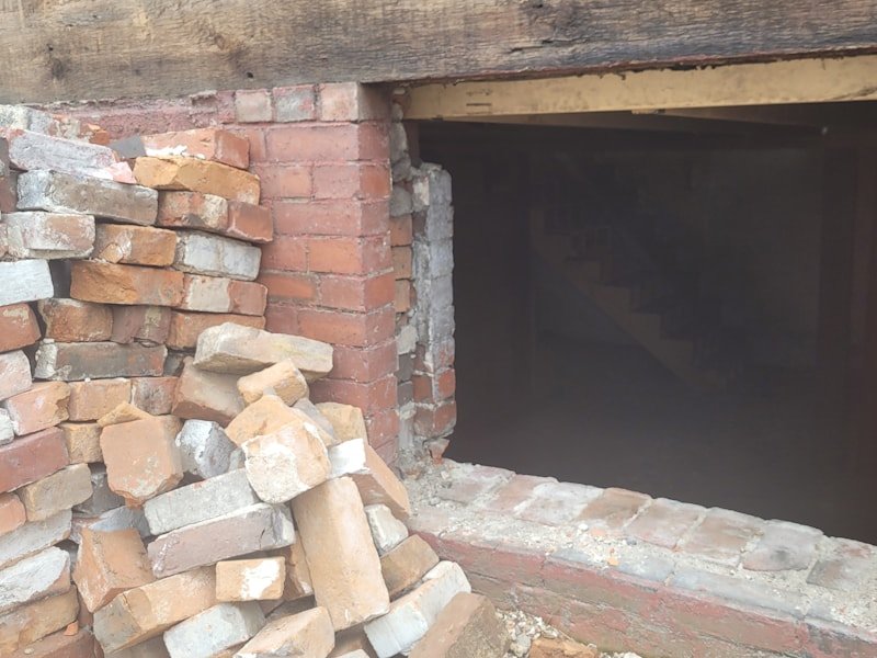 A masonry opening cut back with brick removed ready for a new unit