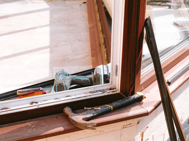 Hand tools resting on a window sill with the existing frame retained